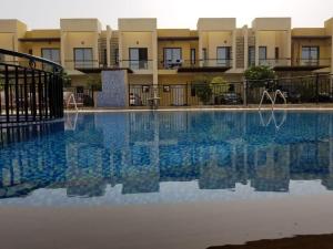a swimming pool in front of some apartments at 2-Bedrooms TownHouse Villa dxb Gplus1 in Dubai