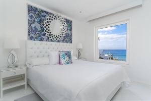 A bed or beds in a room at Lani's Suites de Luxe - Adults Only
