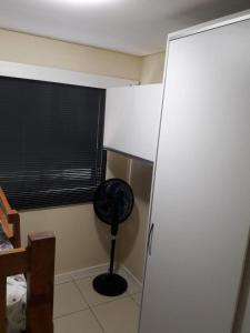 a room with a room with a fan and a window at Apartamento na melhor localização de Recife in Recife +3 photos
