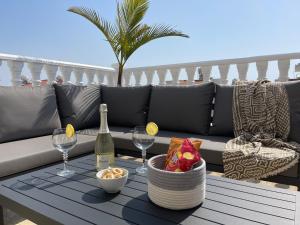 een tafel met een fles wijn en glazen op een balkon bij Nissi Paradise front beach Apt in Ayia Napa