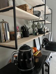 a tea kettle on a stove in a kitchen at Market on 5 in Piet Retief +24 photos