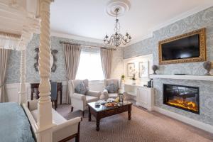 a living room with a fireplace and a bed at Clanard Court Hotel in Athy