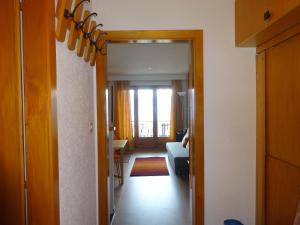 a hallway with a door leading to a living room at The white fox's family home - Veysonnaz in Veysonnaz