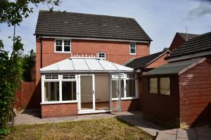 a extension to a red brick house with a conservatory at Stylish 4beds house with parking for contractors & families, HS2 NEC in Marston Green