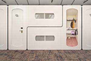 a row of white garage doors in a room at CityHub Amsterdam in Amsterdam