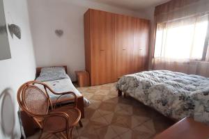 a bedroom with a bed and a table and chairs at La casa di Heidi in Serra deʼ Conti