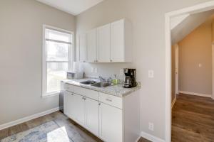 a kitchen with white cabinets and a sink at Indianapolis Home with Porch - Close to Mile Square! in Indianapolis