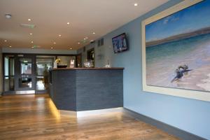 a lobby with a large painting on the wall at County Arms in Truro