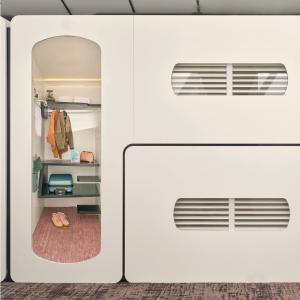 an open door to a room with a closet at CityHub Amsterdam in Amsterdam