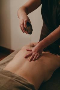 a woman is getting her belly pierced with a scrubber at Silverstone by Alpine Residences in Val-d'Isère