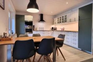 a kitchen with a wooden table and black chairs at Ferienwohnung Wipperau II in Uelzen