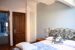 a bedroom with two beds and a wooden door at IL GINEPRO B&B in Piamaggio