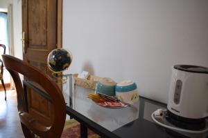 a glass table with a coffee maker on top of it at IL GINEPRO B&B in Piamaggio