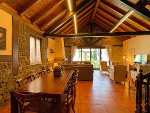 a living room with a wooden table and a couch at Casa Rural juaningratxi in Isaba