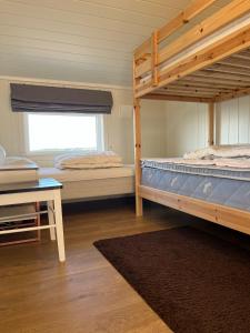 two bunk beds in a room with a window at Apartment with amazing views - free parking in Arendal