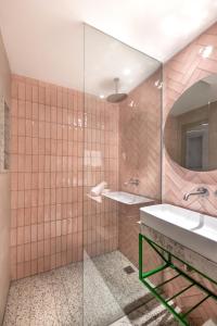 a bathroom with a sink and a mirror at Hotel Shoshana - Adults Only in Eilat