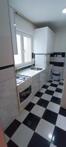a kitchen with a black and white checkered floor at Bascarsija Moon in Sarajevo