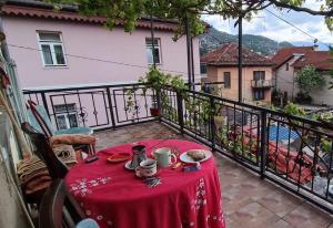 a table with a red table cloth on a balcony at Bascarsija Moon in Sarajevo