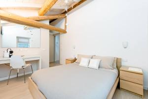 a bedroom with a bed and a desk and a chair at B&B Il Piccolo Principe in Bieno