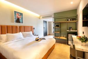 a bedroom with a large bed and a fireplace at Hotel Shoshana - Adults Only in Eilat