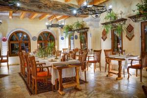 a restaurant with tables and chairs in a room at Petra Inn Cappadocia in Uchisar