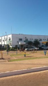 a building with a parking lot with playground equipment at Inácios Hotel ltda in Redenção