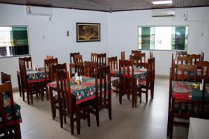 a dining room with a table and chairs at Inácios Hotel ltda in Redenção