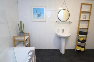a bathroom with a sink and a mirror at Bliss on the Bay in Eastbourne