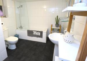 a small bathroom with a toilet and a sink at Bliss on the Bay in Eastbourne