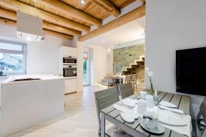 a kitchen and dining room with a table and chairs at B&B Il Piccolo Principe in Bieno