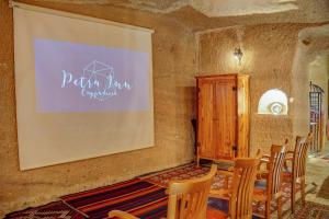 a meeting room with chairs and a projection screen at Petra Inn Cappadocia in Uchisar