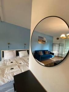 a mirror in a room with a bed and a couch at apartment with balcony in Berlin