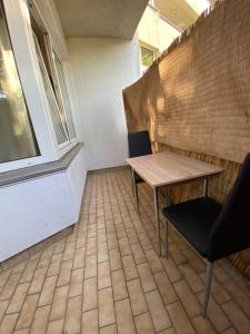 a room with a table and two chairs and a window at apartment with balcony in Berlin