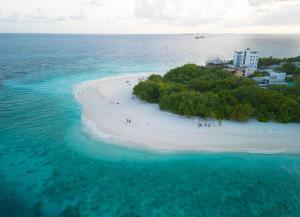 an island in the ocean with people on the beach at Beach Veli in Ukulhas