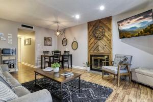 a living room with a couch and a table at Cozy Resort-Style Condo Less Than 2 Mi to Ober Gatlinburg! in Gatlinburg