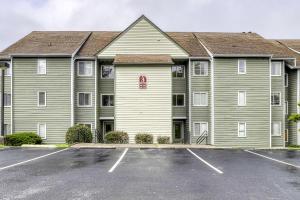 a large apartment building with a parking lot at Cozy Resort-Style Condo Less Than 2 Mi to Ober Gatlinburg! in Gatlinburg