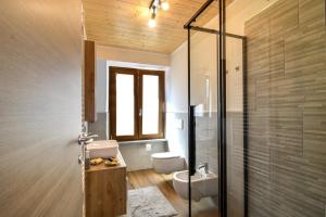 a bathroom with a toilet and a glass shower at La Terrazza in Malesco