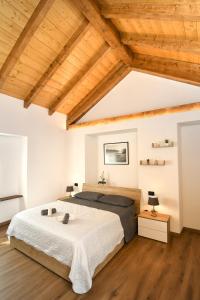a bedroom with a large bed and wooden ceilings at La Terrazza in Malesco