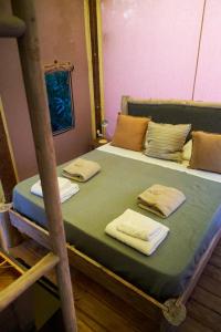 a bedroom with two bunk beds with towels on them at Procida Camp & Resort - La Caravella in Procida
