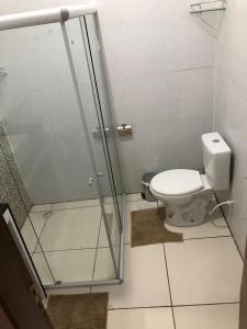 a bathroom with a toilet and a glass shower stall at P nacional do catimbau Buíque de 1 a 10 hospeder in Catimbau