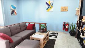 a living room with a couch and a table at Isle Inn Guesthouse in Fuvahmulah