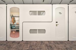 a row of white garage doors in a room at CityHub Amsterdam in Amsterdam