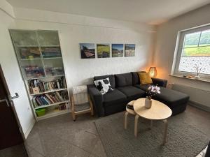 a living room with a couch and a table at Ferienwohnung Brandenburger in Schmallenberg