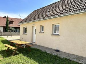 a wooden picnic table in front of a building at So Sweet in Bligny-lès-Beaune