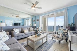 a living room with a couch and a table at Twin Palms Beach Resort by Panhandle Getaways in Panama City Beach