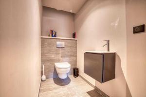 a bathroom with a toilet and a sink at High standing 6P3BR apartment - Résidence Stallion Megève in Megève
