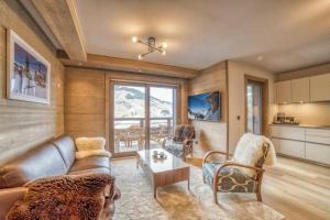 a living room with a couch and a table at High standing 6P3BR apartment - Résidence Stallion Megève in Megève