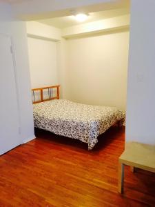 a bedroom with a bed in a room with wooden floors at Stylish Montreal Apartment: Comfortable Stay in the Golden Square Mile in Montreal