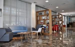 a living room with a couch and chairs and a table at Hotel Castilla Alicante in Alicante