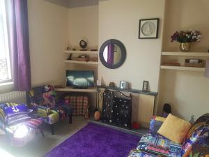 a living room with a couch and a tv at No 3 Lingdale - 4 bedroom house close to N Yorks Moors in Boosbeck